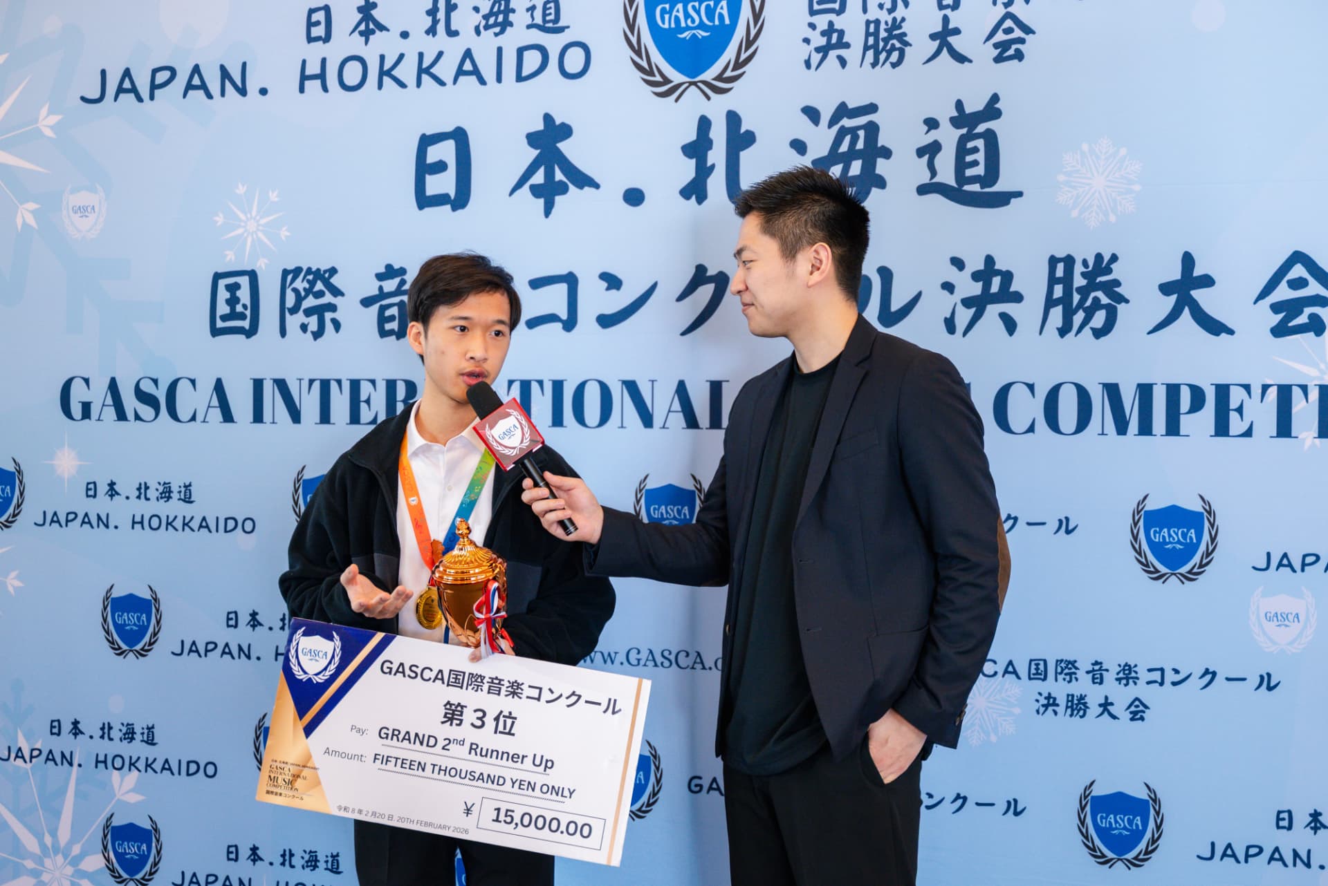 Hokkaido second runner-up being interviewed with trophy and giant cheque