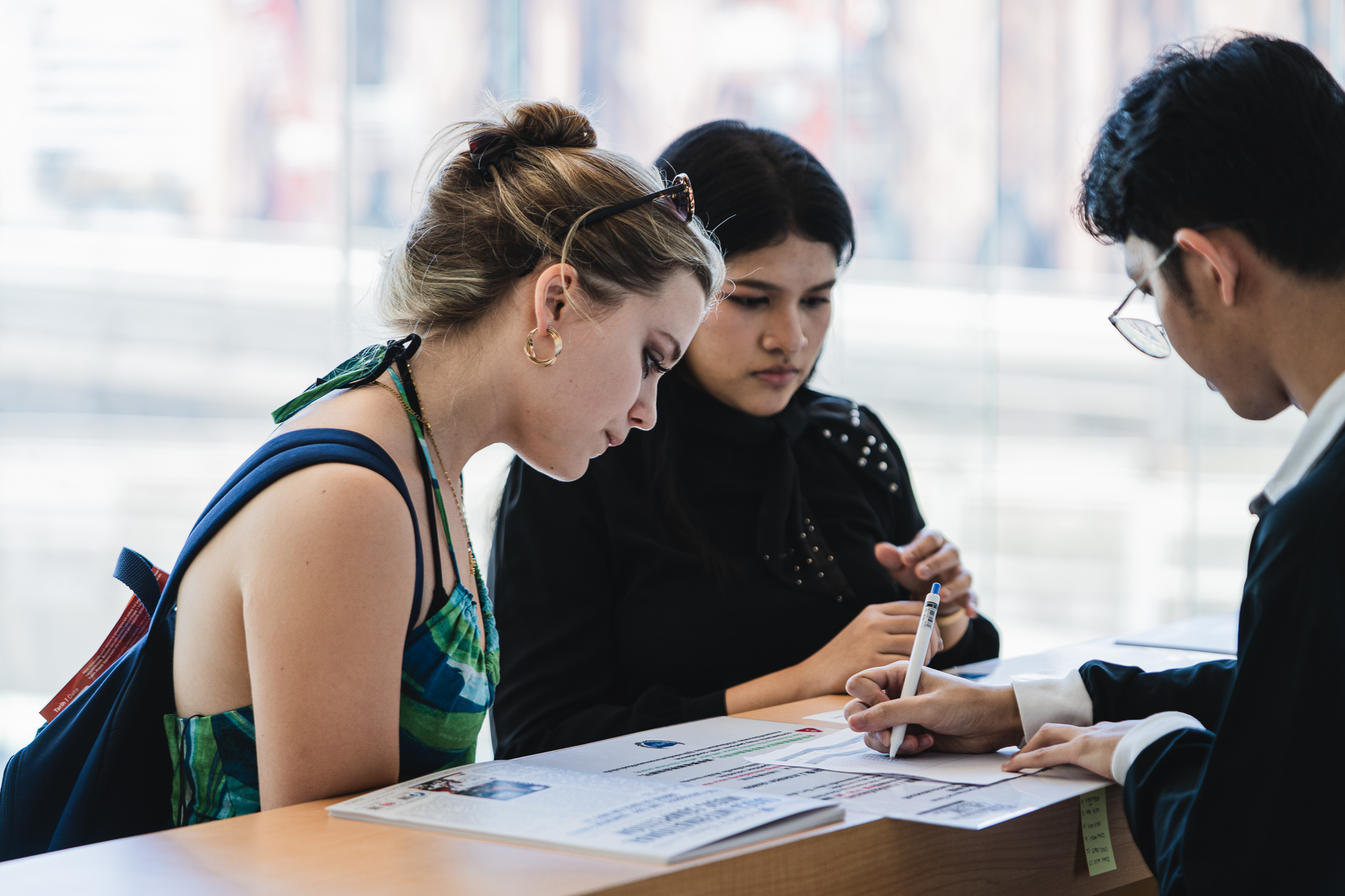 Registration desk with participants and adjudicator paperwork